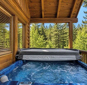 A hot tub with a wooden deck and a view of trees. - Dolly's View Lodge | Games • Hot Tub • Best Views (Sevierville)