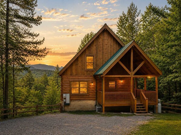 A wooden cabin with a porch, a covered staircase, and a view of the surrounding forest. - Dolly's View Lodge | Games • Hot Tub • Best Views (Sevierville)