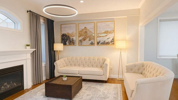 A living room with a fireplace, a sofa, a coffee table, and a lamp. - 4 bedroom upper unit in Brampton (Brampton)