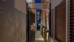 A narrow alleyway leading to a gated entrance labeled "LUXE SUITES AND SPA". - Sanctuary Hobart CBD (Hobart)