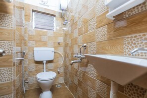 A bathroom with a toilet, sink, and shower. - City Haven by Jadecaps Nr. Belle Vue Hsp 3bhk (Kolkata)