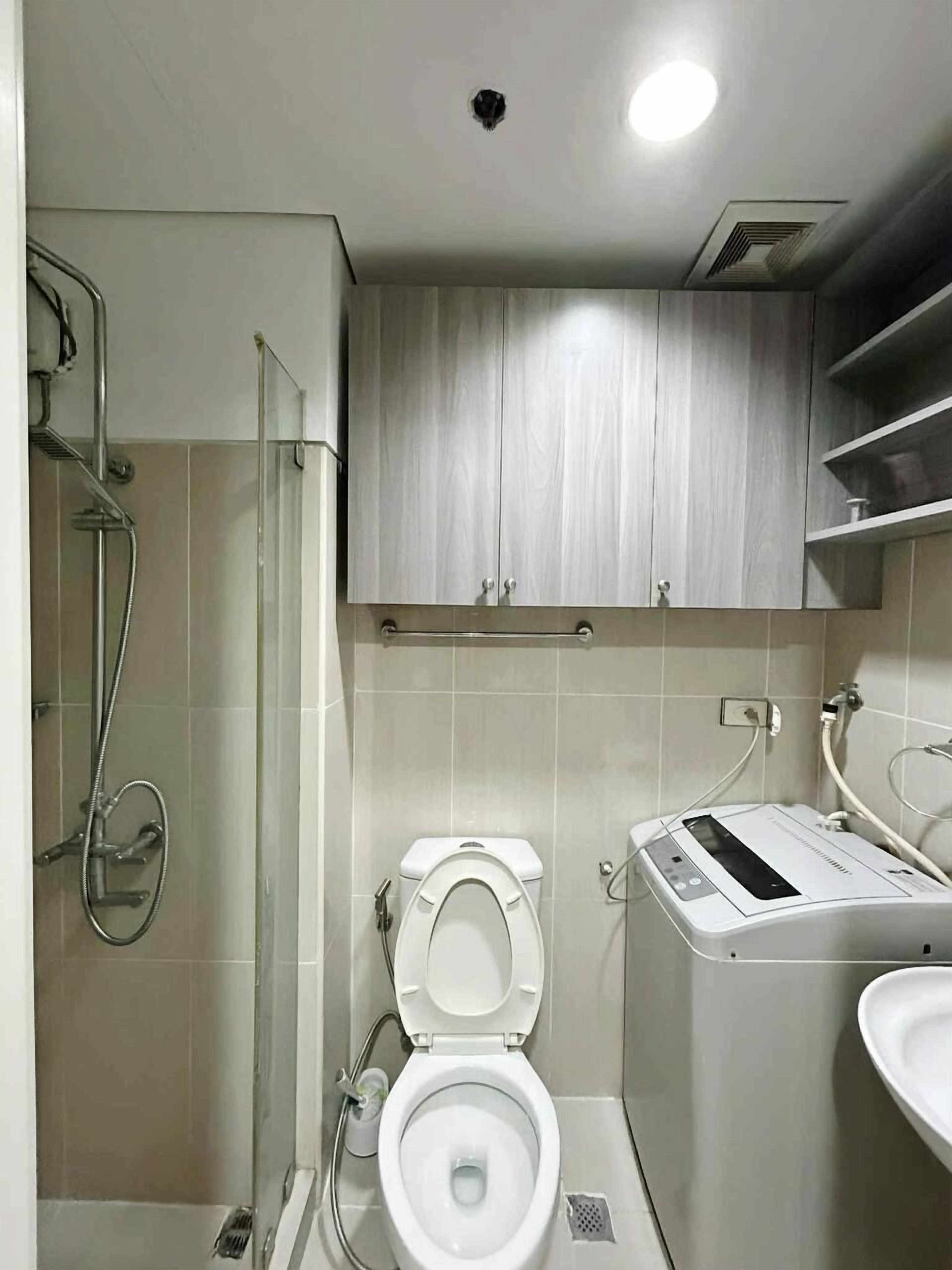 A modern bathroom with a toilet, bidet, and shower.