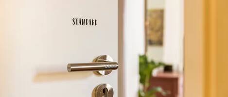 A door with a standard lock and a keyhole, with the word "STANDARD" above the lock.