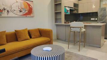 Luxury Apartment | Living area | 32-inch flat-screen TV with cable channels