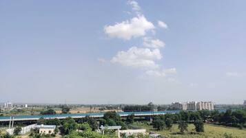 A view of a residential area with buildings, greenery, and a clear sky.