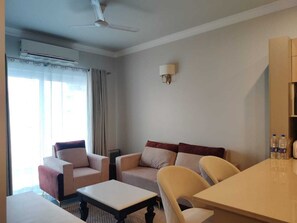 Luxury Apartment | Living area | 32-inch flat-screen TV with cable channels - Central Park Flower Valley (Gurugram)