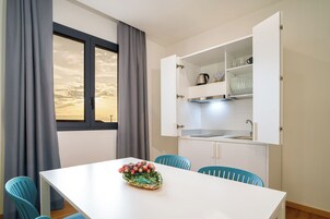 Deluxe Apartment, Pool View | Living area | 50-inch LED TV with cable channels