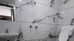 A bathroom with a sink, toilet, and shower. - Hotel S M INN near Temple & Main Places (Ujjain)