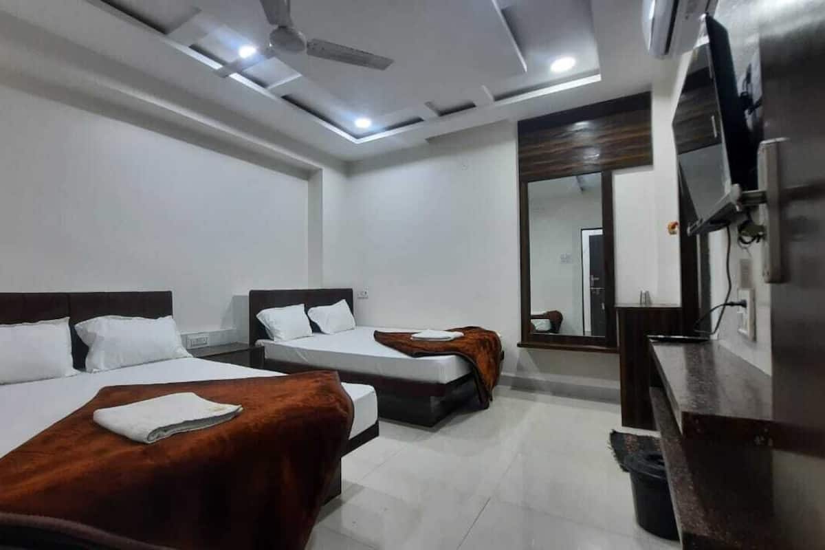 Deluxe Quadruple Room | Premium bedding, desk, laptop workspace, soundproofing