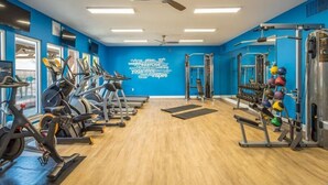 A gym with exercise equipment, a ceiling fan, and motivational words on the wall. - Modern Comfort w/ Balcony, Kitchen & WiFi (Birmingham)