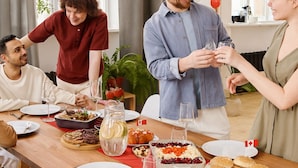 A dining table set with various dishes, glasses, and a Canadian flag.