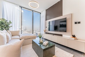 TV - Prime 1BR, Few minutes Drive to Burj Khalifa and Dubai Mall - Sobha Hartland The Crest Tower C  by Deluxe Holiday Homes (Dubai)