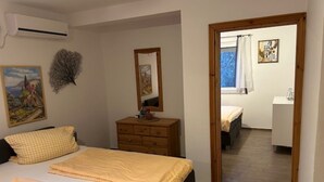 A bedroom with a bed, dresser, and a mirror. There is a window with curtains and a painting on the wall. - Villa nikki, ideal base in croatia, 5o meters from the lake (Bilice)