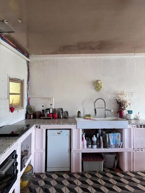 A compact kitchen with a white countertop, a built-in sink, and a small refrigerator. - Ardèche - Unique home in the Bésorgues Valley. (Freyssenet Labastide-sur-Bésorgues)