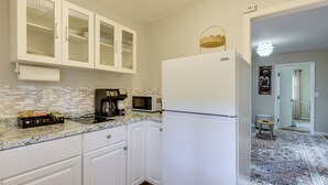 A kitchen with white cabinets, a white refrigerator, a microwave, and a coffee maker. - Convenient + Cozy! Apartment in DC Suburbs! (Silver Spring)