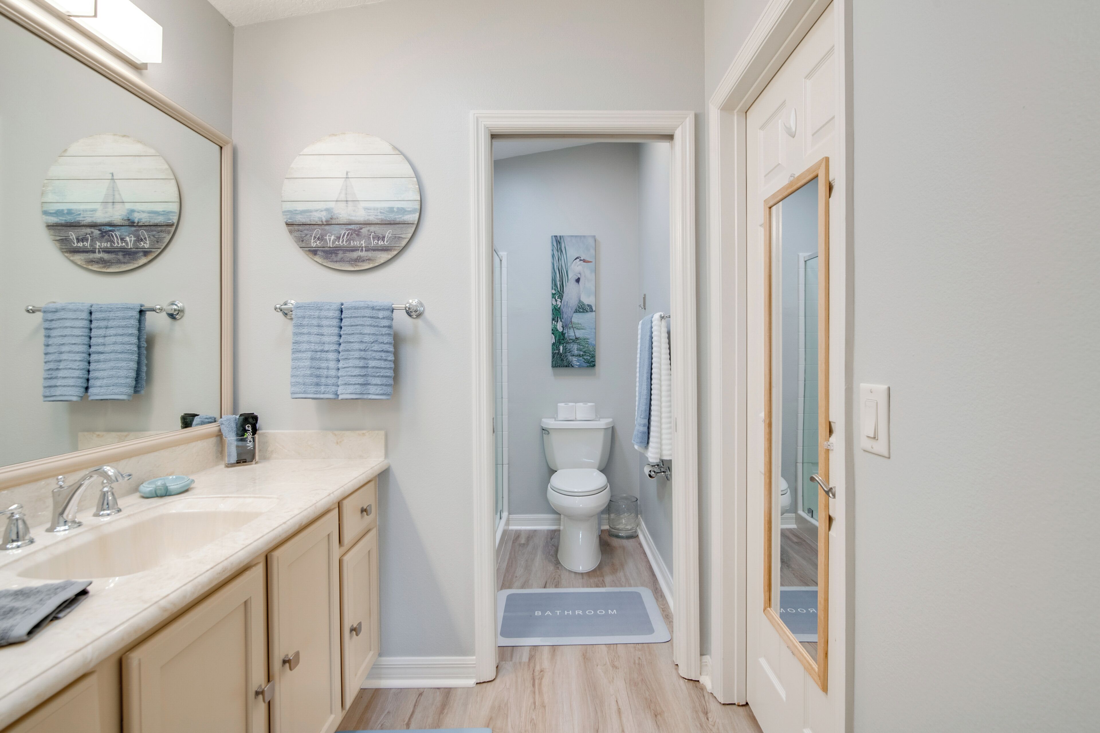 A bathroom with a sink, mirror, and toilet.