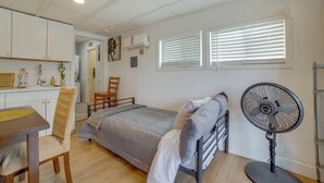 A compact room with a bed, a dining table, a chair, a fan, and a window with blinds. - 5 Mi to Dtwn Riverside & Hospital! Remote-work Hub (Riverside)