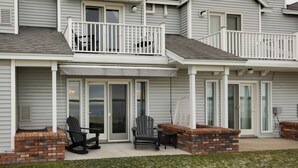 A two-story townhouse with a covered front porch, sliding glass doors, and a brick accent wall. - Stunning Views & Beach Access: Plattsburgh Getaway (Plattsburgh)