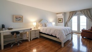 A bedroom with a bed, a desk, a chair, and a nightstand. - Stunning Views & Beach Access: Plattsburgh Getaway (Plattsburgh)