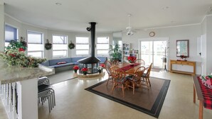 A spacious living room with a fireplace, a dining area, and a kitchen. - Stunning Views & Beach Access: Plattsburgh Getaway (Plattsburgh)