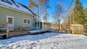 A light green house with a covered porch and a wooden deck. - Hiking & Skiing Galore! Home in East Wallingford (East Wallingford)