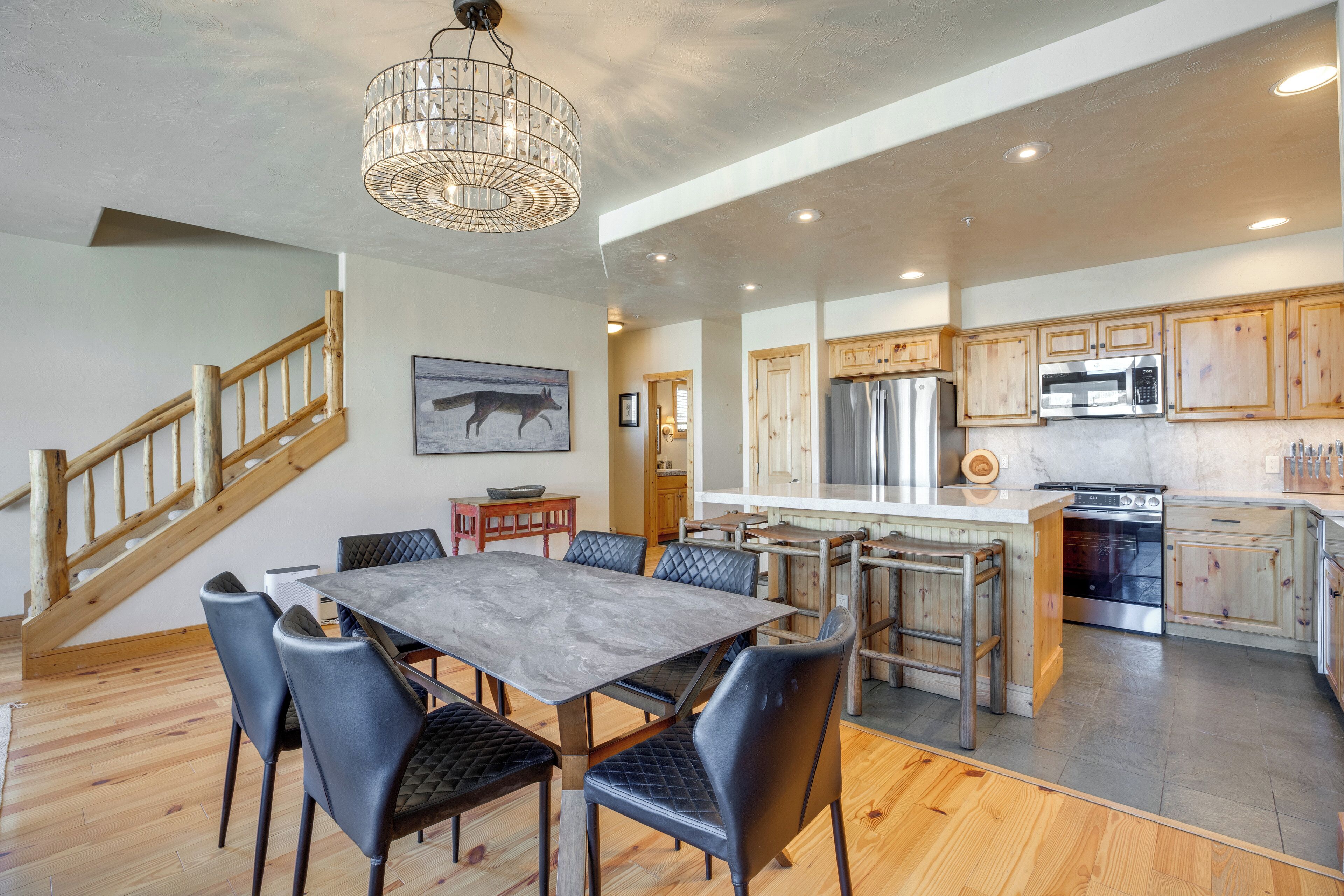 A spacious kitchen with wooden cabinets, a large island, and modern appliances.