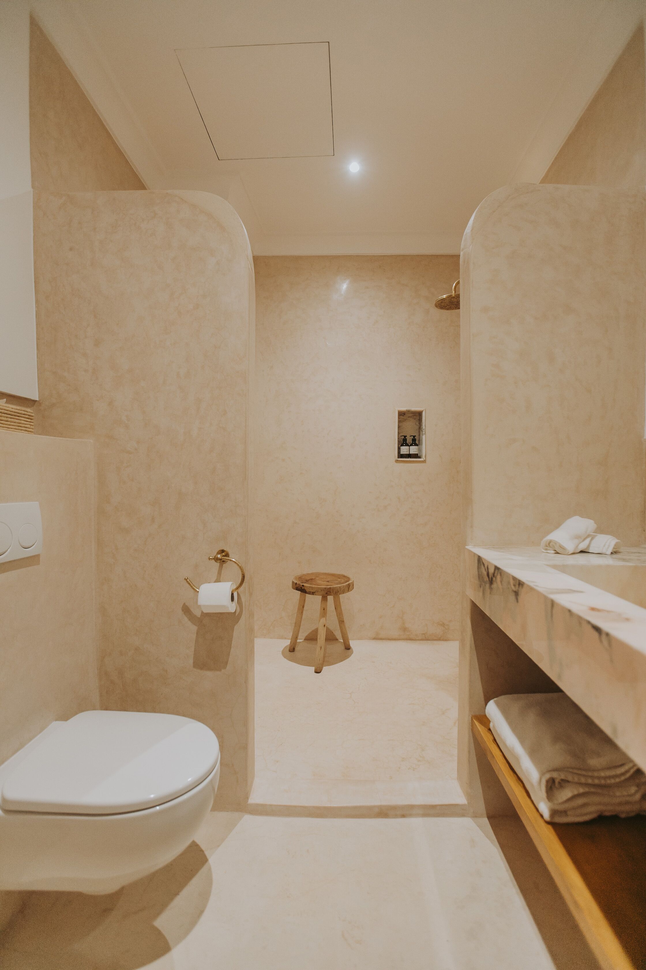 A modern bathroom with a toilet, sink, and vanity.
