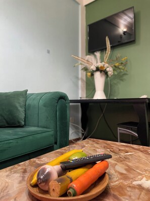 Deluxe Studio, 1 Queen Bed, Balcony, Courtyard View | Living area | 24-inch flat-screen TV with cable channels, pay movies - NGK HOTEL APARTMENT (Bafoussam)