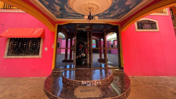 A brightly colored building with a marble entrance and a decorative ceiling. - NGK HOTEL APARTMENT (Bafoussam)