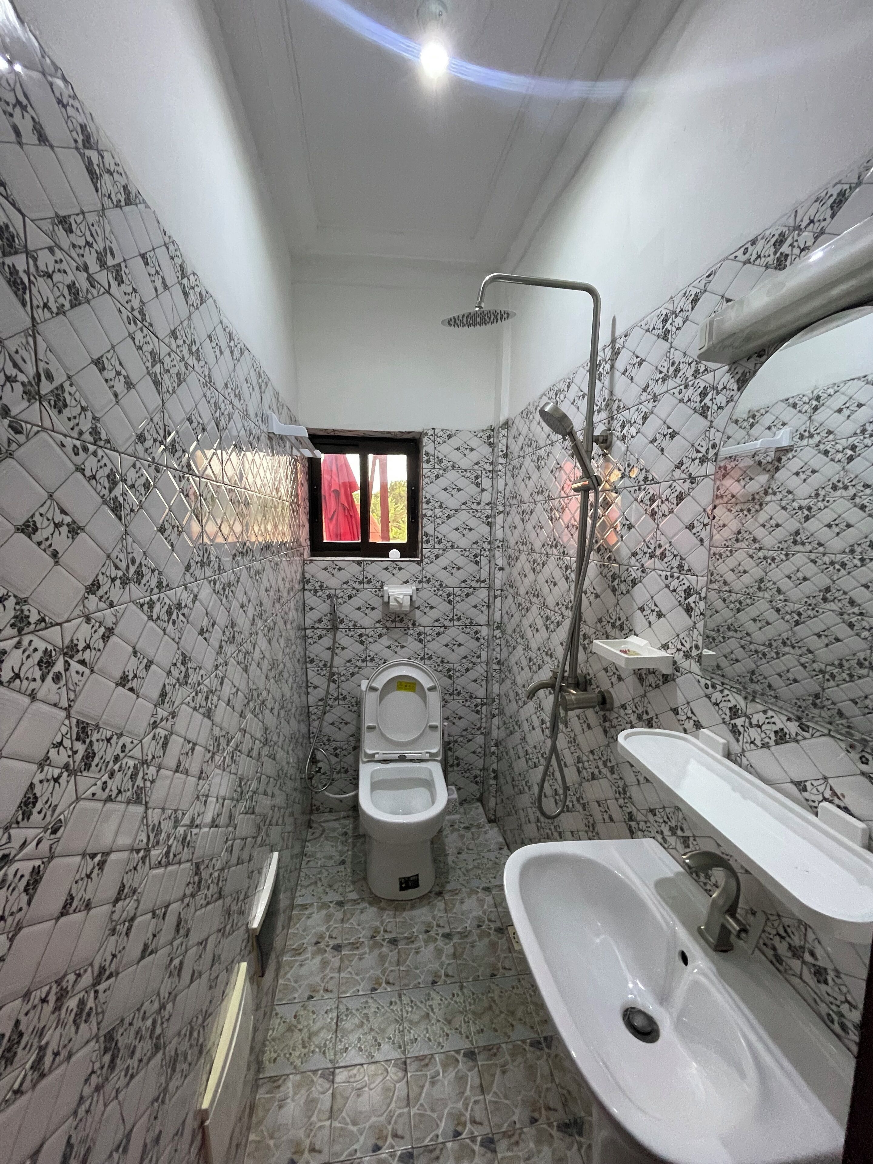 A bathroom with a toilet, bidet, and sink.