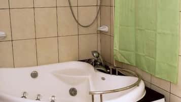 Bathtub, free toiletries, slippers, towels