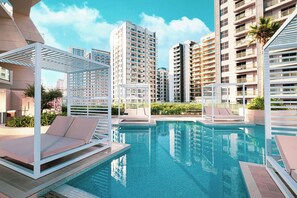 Indoor pool, outdoor pool, open 9:00 AM to 9:00 PM, pool umbrellas - Binghatti Phantom Suites by Hostiva (Dubai)