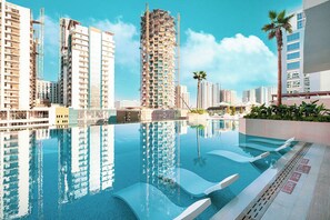 Indoor pool, outdoor pool, open 9:00 AM to 9:00 PM, pool umbrellas - Binghatti Phantom Suites by Hostiva (Dubai)