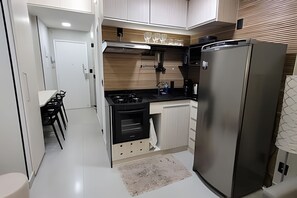 Departamento | Cocina privada | Refrigerador con congelador, microondas, horno y parrilla de estufa 