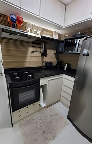 Departamento | Cocina privada | Refrigerador con congelador, microondas, horno y parrilla de estufa 