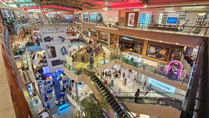 A multi-level shopping mall with various stores and a central atrium. - Azure Palace (Patong)