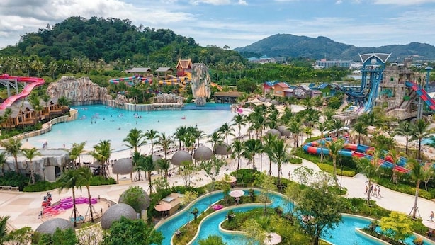 A resort with multiple swimming pools, water slides, and a large rock formation. - Azure Palace (Patong)