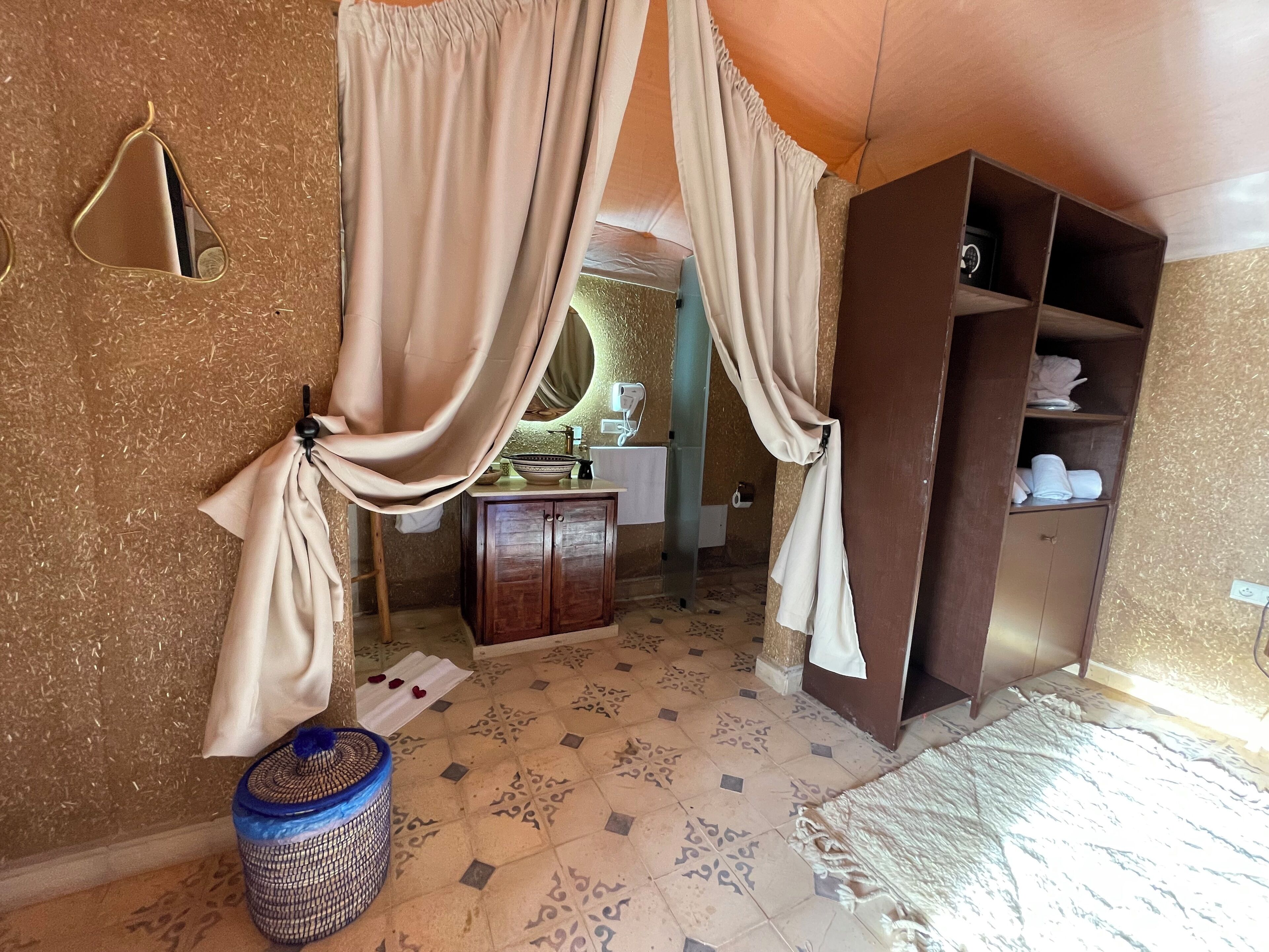 A bathroom with a sink, mirror, and cabinet.