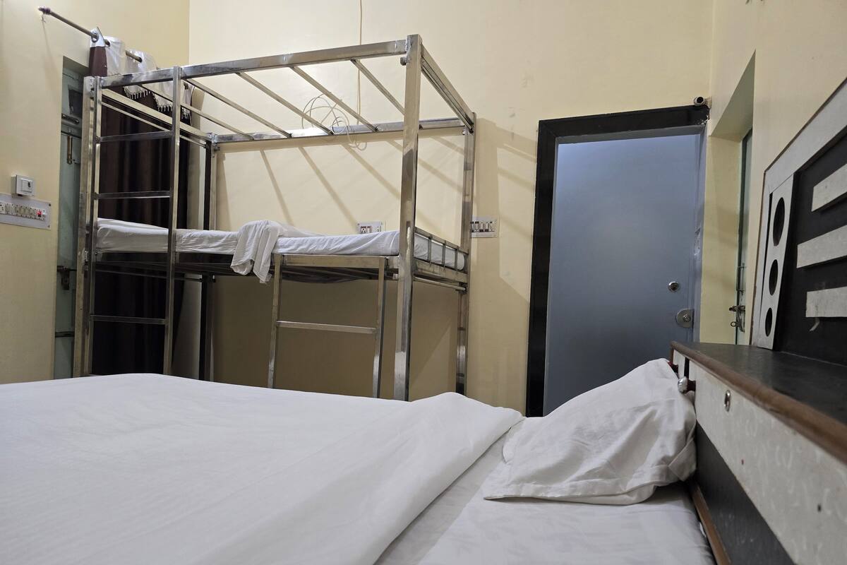 A bunk bed room with a door and a small table.