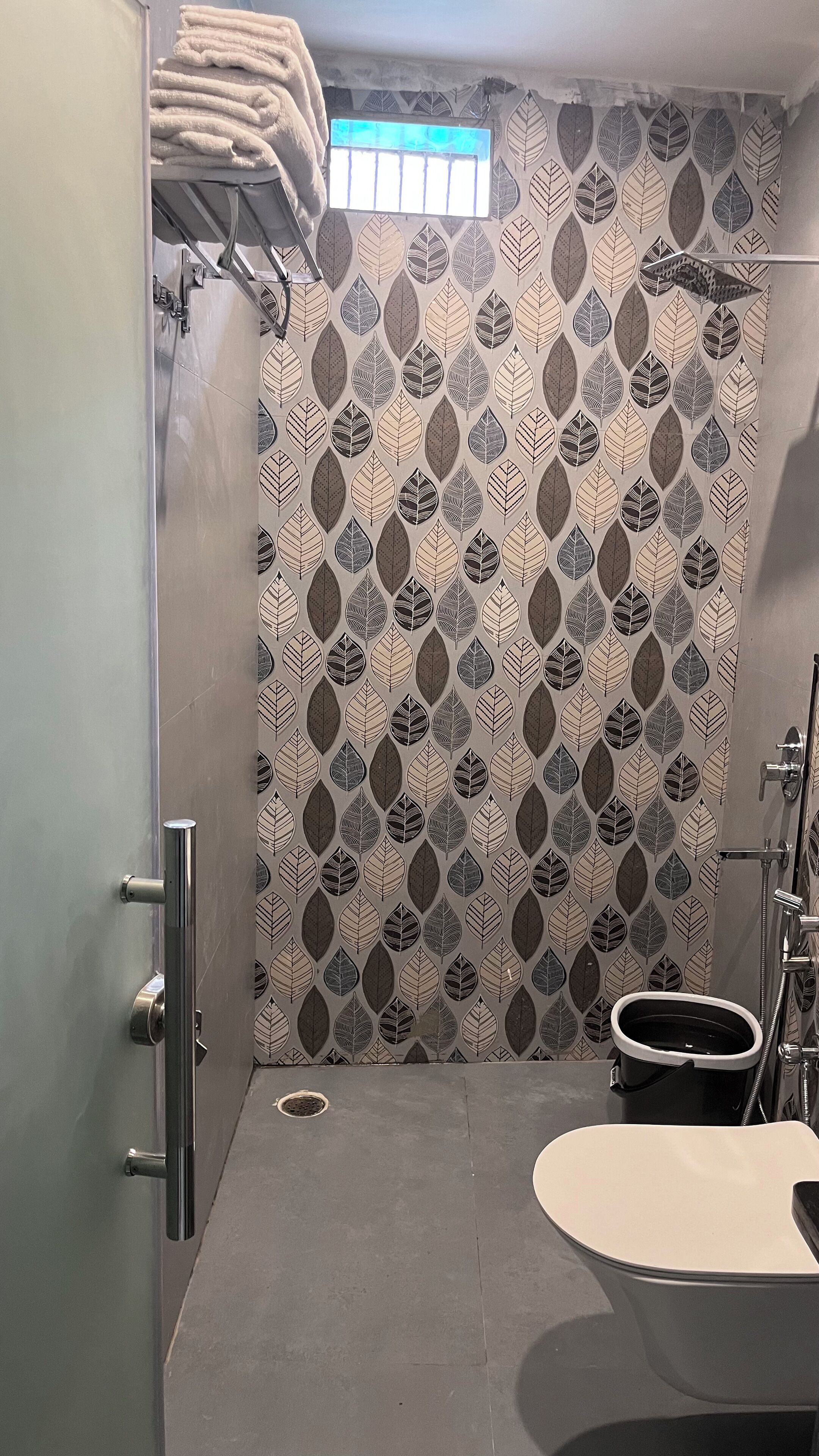 A bathroom with a shower, a toilet, and a sink.