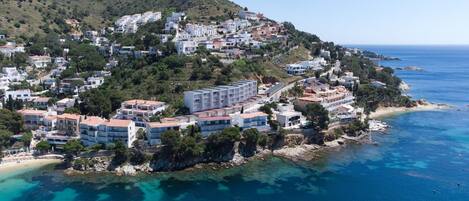A coastal town with buildings on a hillside overlooking the sea.