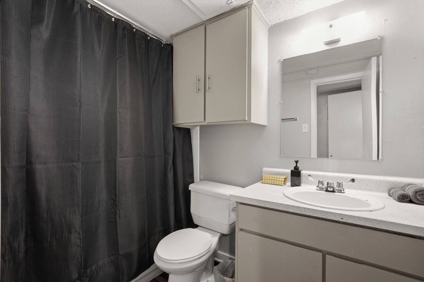 Ein Badezimmer mit Toilette, Waschbecken und Spiegel.