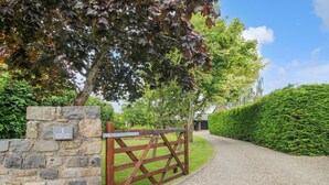 A stone wall with a metal gate and a sign reading "1 Clark's Lane." - 1 Clarkes Lane (Oswestry)