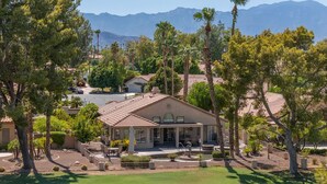 A residential property with a patio, outdoor seating, and a view of mountains. - Peaceful 3 bed 2 bath spacious home at Avondale Golf Club Palm Desert (Palm Desert)