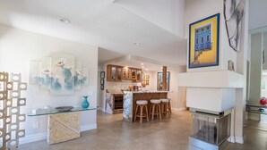 A spacious kitchen with a central island, wooden cabinets, and a fireplace. - Peaceful 3 bed 2 bath spacious home at Avondale Golf Club Palm Desert (Palm Desert)