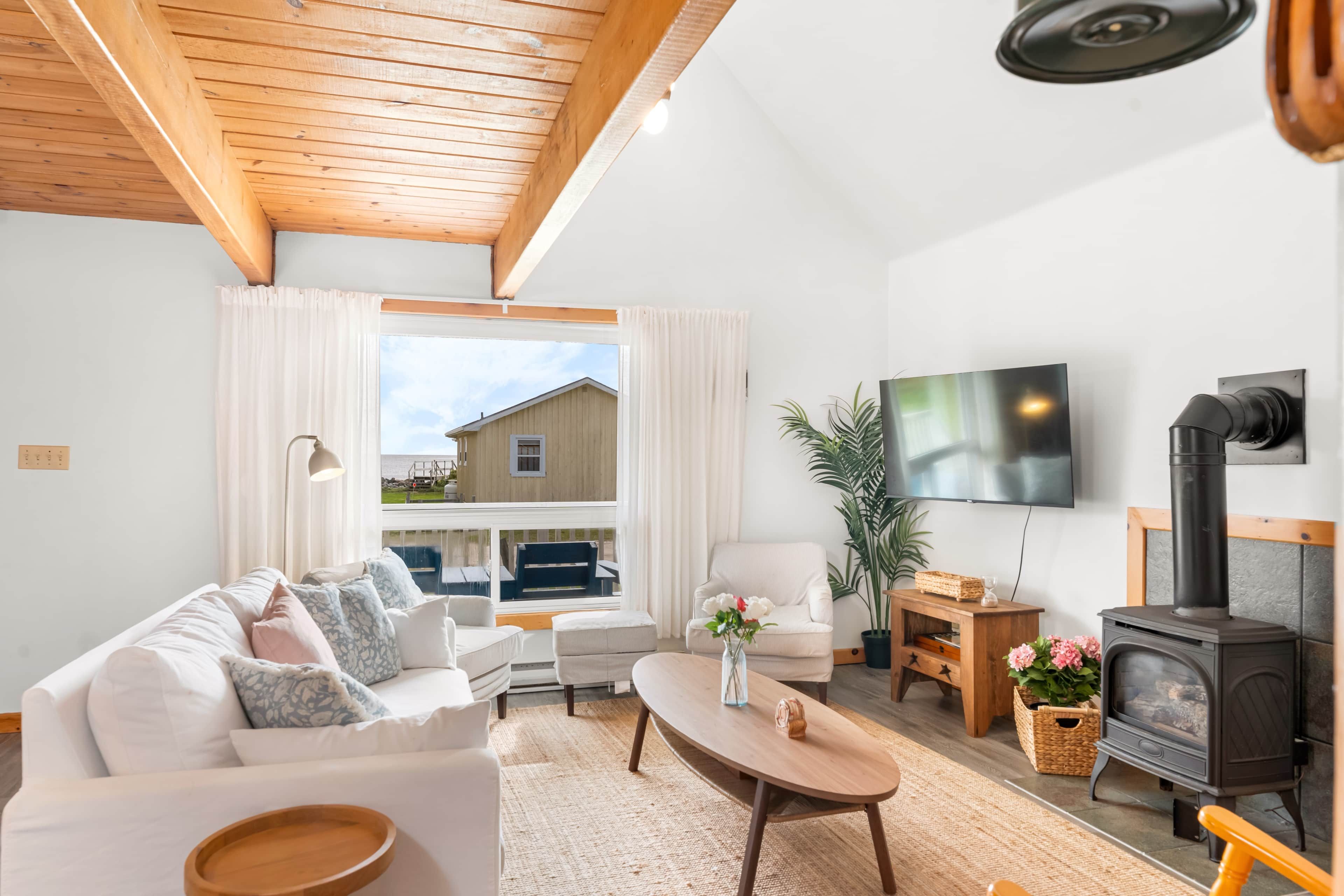 A cozy living room with a sofa, coffee table, and a fireplace.