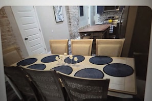A dining area with a table set for six, surrounded by chairs. - Wonderful 5-bedroom bed & breakfast in vibrant New Orleans (New Orleans)