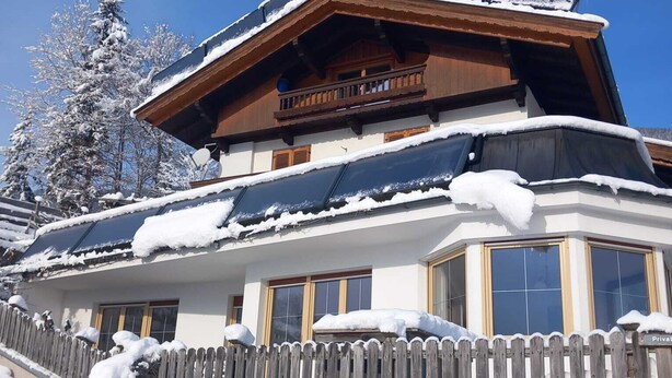 A traditional chalet with a sloped roof, wooden balcony, and a sign indicating it is private property. - House at the edge of the forest Thiersee (Thiersee)