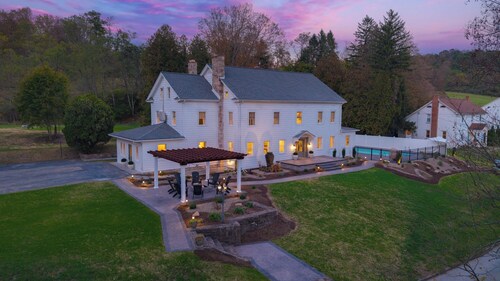 Experience luxury and relaxation at The Manor at Greene Hills Resort & Campground. This spacious retreat features 7 king bedrooms, cozy bunk rooms, a fully equipped chef’s kitchen, and elegant living spaces. Enjoy your private pool, hot tub, and saun