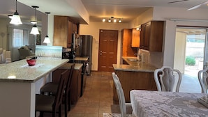 A modern kitchen with granite countertops, stainless steel appliances, and pendant lighting. - Serene 3-bedroom house in Sun City
Golf course & lake front near Stadium. (Sun City)